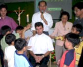 Bro. Pete prays over Msgr. Christophe